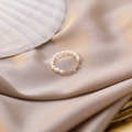 Detail of handmade beaded ring with white pearls, pink crystal stones and gold beads - Purple