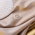 Detailed macro view of handmade pearl ring with blue natural stones on satin - Blue