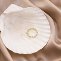Detail of handmade beaded ring with freshwater pearls and yellow crystals on a shell - Yellow