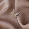 Detailed macro view of golden butterfly ear cuff encrusted with sparkling zircons - Gold Butterfly Style
