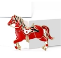 Close-up of red enamel horse brooch with gold base and sparkling red rhinestone details - Red