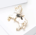 Detailed view of horse-shaped brooch with white oil dripping and sparkling diamonds - White