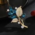 Elegant gold orchid brooch with deep blue stones and white zircon crystals on dark background - Orchid Leaf Style