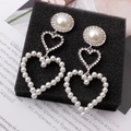 Detail of bridal drop earrings with pearls, rhinestones and heart-shaped pendants - Silver