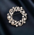 Elegante spilla a corona d'argento con cristalli scintillanti su tessuto di seta blu scuro - Argento