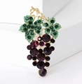 Detailed close-up of a golden grape brooch with green rhinestones and purple crystals - Deep Purple Grape Style