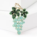 Macro shot of grape brooch with green crystal leaves and mint blue gemstone clusters - Green Grape Style