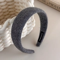 Detalle de diadema de lana gris oscuro con etiqueta artesanal sobre cesta de punto - Estilo Gris (27562B)