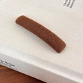 Detailed view of dark brown plush hair clip with soft wool texture on minimalist book - Dark Coffee