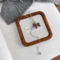Detail of vintage horse pendant with golden star and silver snake chain on knitwear - Coffee (27608B)