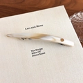 Detail of marble pattern acetate spring hair clip with a round gold logo on book - White Multi-color (27606B)