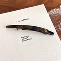 Detail of tortoise shell acetate spring hair clip with a gold metal logo emblem - Black Multi-color (27606F)