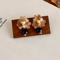 Close-up of vintage geometric earrings with amber petals and black beads on wood - Colorful Flower Bead (27624A)