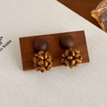Macro shot of retro geometric wooden earrings with woven bead details on a wooden stand - Wood Bead Cluster (27624B)