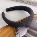 Detailed view of dark grey ribbed padded headband featuring a handmade inner label - Dark Gray