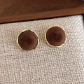 Detail of round brown velvet stud earrings with elegant gold metallic borders - Brown Round Style
