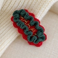 Close-up of handmade knitted Christmas hair clip with red and green crochet patterns - Red Base Green Lace (27706H)