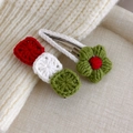 Close-up of handmade crochet Christmas hair clips with red flower and knit patterns - Green Small Flower Pair (27706P)