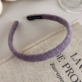 Detailed close-up of purple knit headband texture with handmade label detail - Purple