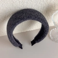Close-up detail of dark grey plush headband with thick fluffy texture and black lining - Gray