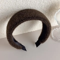 Detail of plush faux fur headband in dark brown featuring a wide and thick padded texture - Green