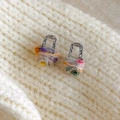 Close-up of rainbow knit wool earrings with silver hammer-textured U-shape hooks - Pink Multicolor