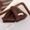 Macro view of plush dark coffee wool texture and Little Freshness tag on hair claw - Dark Coffee