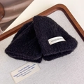 Detailed macro view of black fuzzy hair claw clip with Little Freshness label text - Black