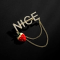 Elegant NICE crystal brooch with red strawberry pendant and gold chains on black background - Gold NICE Strawberry Tassel