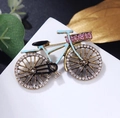 Macro detail of a vintage bicycle brooch with light blue enamel and sparkling rhinestones - Lake Blue