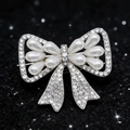 Elegant silver bow brooch with sparkling crystals and water-drop imitation pearls - Silver