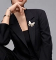 Elegant gold butterfly brooch with white wings and pearl accent on a black blazer - Butterfly Style (sku_599226485877)