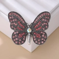 Elegante spilla a farfalla d'argento con strass rosa e rossi su supporto in pelle - Design a Farfalla / Rosa