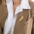 Elegant gold feather brooch with pearls and crystals pinned on a brown blazer lapel - Gold Feather Style (X112543)