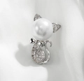 Close-up of cute cat brooch with white pearl head and zircon-studded silver body - Silver