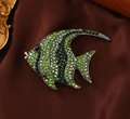 Macro view of crystal fish brooch with green rhinestones and vintage bronze finish - Tropical Fish Shape / Green