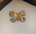 Macro shot of luxury gold butterfly brooch featuring colorful crystal rhinestones - Colorful Rhinestone
