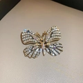 Elegant gold butterfly brooch with shimmering rhinestones for suits and coats - White Rhinestone