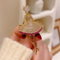 Elegant gold ballerina brooch featuring white zircons and pink gemstones on dancer dress - Ballet Girl