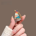 Macro shot of a colorful enamel sailboat brooch with gold alloy frame and rhinestones - Sailboat Style (XL0050)