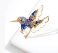 Exquisite gold hummingbird brooch featuring sparkling blue rhinestones and white enamel inlay - Blue