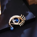 Evil eye crystal brooch in gold with navy blue teardrop gem and sparkling accents - Gold