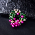 Spilla ghirlanda floreale elegante con perle rosa e smalto verde su fondo in pietra - Ghirlanda di Bacche Dorate (X112919)