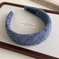 Close-up of blue tweed padded headband with a handmade label on wooden tray - Medium Blue