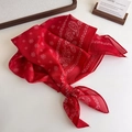 Detailed macro shot of red paisley pattern cotton scarf with white floral motifs - Red Paisley