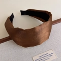 Detail shot of wide satin headband in dark brown showing smooth fabric and inner lining - Brown
