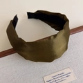 Detailed side view of an olive green satin wide headband with subtle shimmer texture - Green