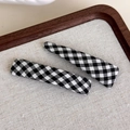 Detail of two black and white plaid BB hair clips on a rustic linen background in a wooden tray - Black and White Checkered
