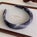 Detail of blue-grey plaid fabric headband showing handmade label and textile texture - Blue Grey Plaid