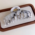 Detail of grey ink marble hair claw clip with golden spring on a wooden tray - Multi-Tooth Large (27267K)